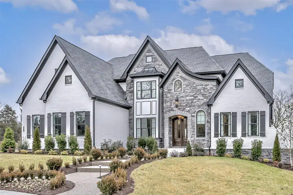 Custom-built home with stone accents and painted siding, illustrating residential construction services.